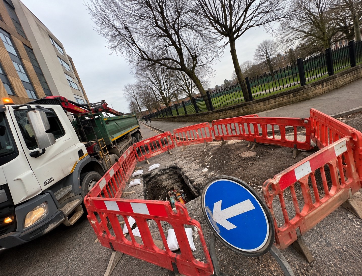 Grab lorry supporting roadworks excavation
